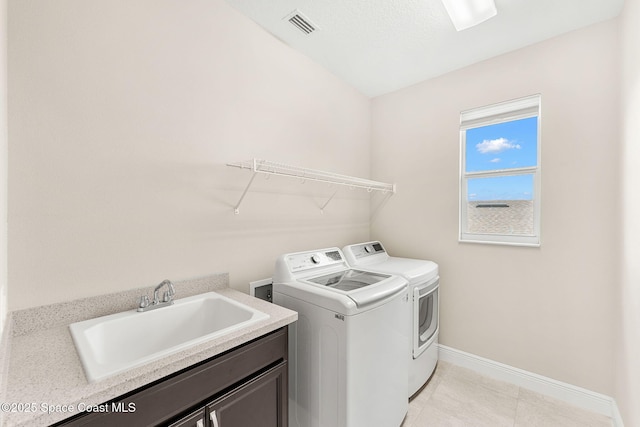2810 Amethyst Way, Melbourne, FL 32940 - laundry area featuring washer and dryer, cabinet space, and light tile patterned floors