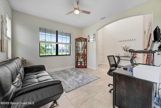 8212 Paragrass Ave, Melbourne, FL 32940 - office area featuring arched walkways, a ceiling fan, light tile patterned floors, and baseboards