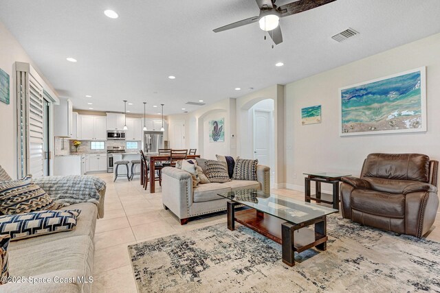 8212 Paragrass Ave, Melbourne, FL 32940 - living area with arched walkways, a ceiling fan, recessed lighting, and light tile patterned flooring