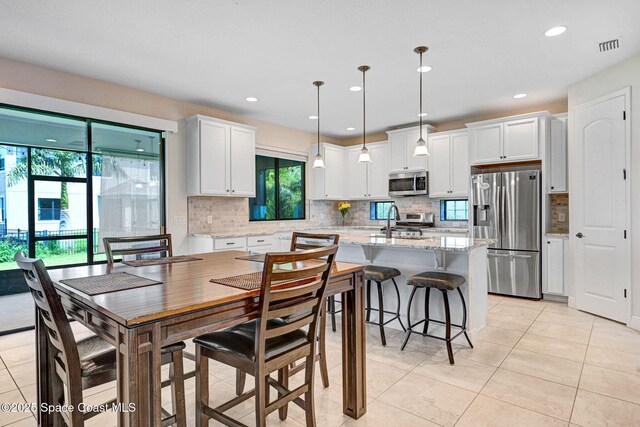 8212 Paragrass Ave, Melbourne, FL 32940 - dining space featuring light tile patterned floors and recessed lighting