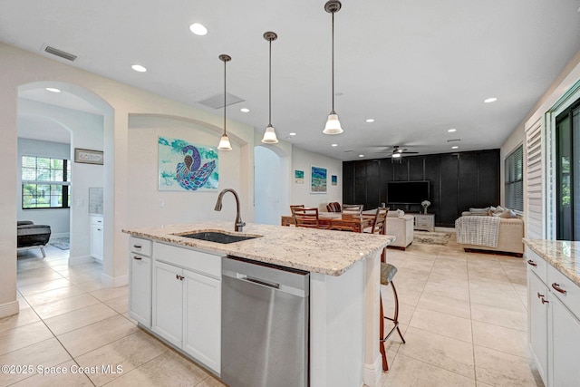 8212 Paragrass Ave, Melbourne, FL 32940 - kitchen with dishwasher, a sink, arched walkways, white cabinetry, and ceiling fan