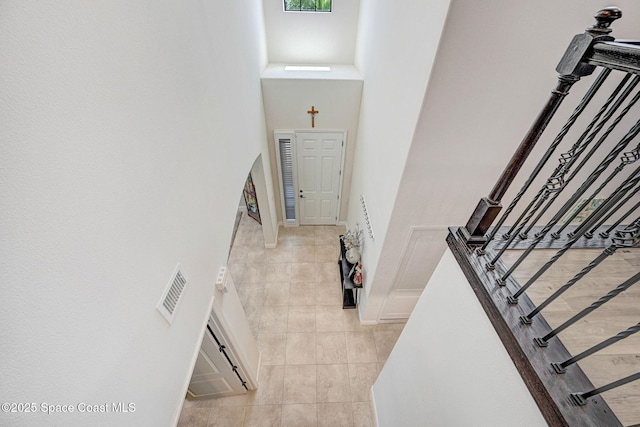8212 Paragrass Ave, Melbourne, FL 32940 - stairway with tile patterned flooring, a high ceiling, and baseboards