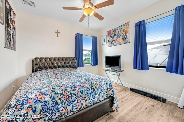 8212 Paragrass Ave, Melbourne, FL 32940 - bedroom featuring baseboards, wood finished floors, and ceiling fan