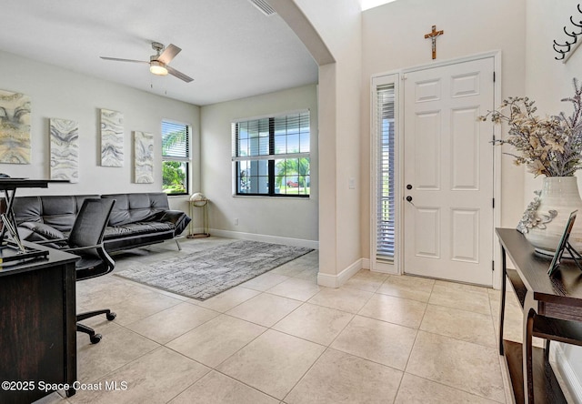 8212 Paragrass Ave, Melbourne, FL 32940 - entryway with arched walkways, a ceiling fan, light tile patterned floors, and baseboards