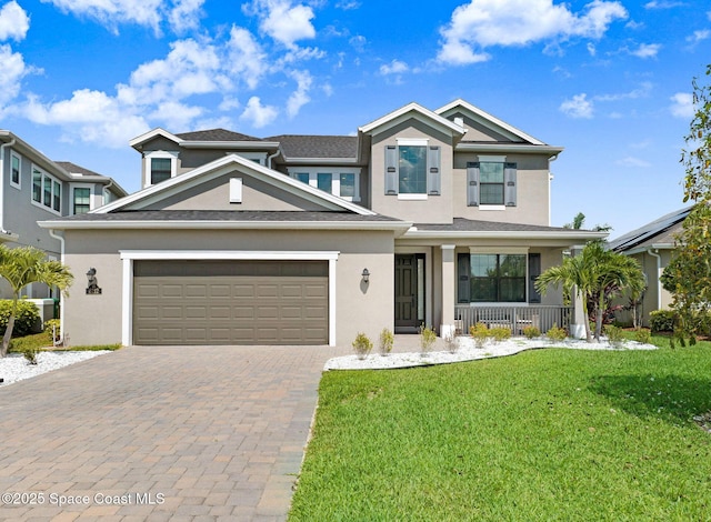 8212 Paragrass Ave, Melbourne, FL 32940 - view of front of house with covered porch, stucco siding, a front lawn, an attached garage, and decorative driveway