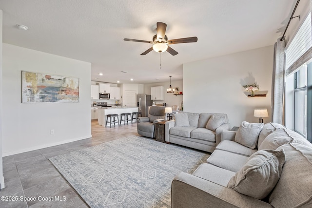 637 Old Country Rd SE, Palm Bay, FL 32909 - living area featuring a ceiling fan, baseboards, and a chandelier