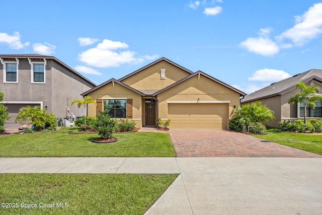 637 Old Country Rd SE, Palm Bay, FL 32909 - view of front facade with decorative driveway, stucco siding, a front yard, and a garage