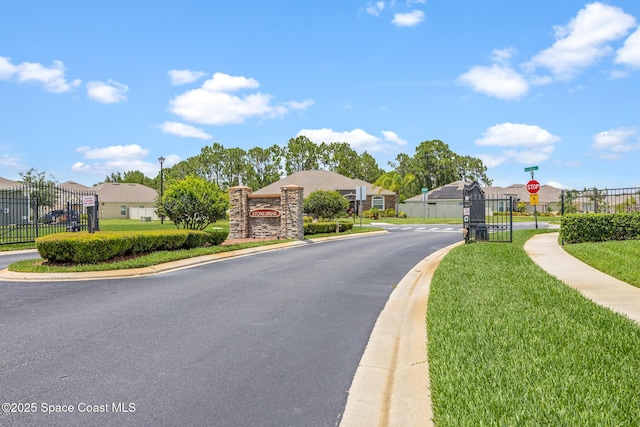 637 Old Country Rd SE, Palm Bay, FL 32909 - view of asphalt road featuring traffic signs, curbs, street lights, and a residential view