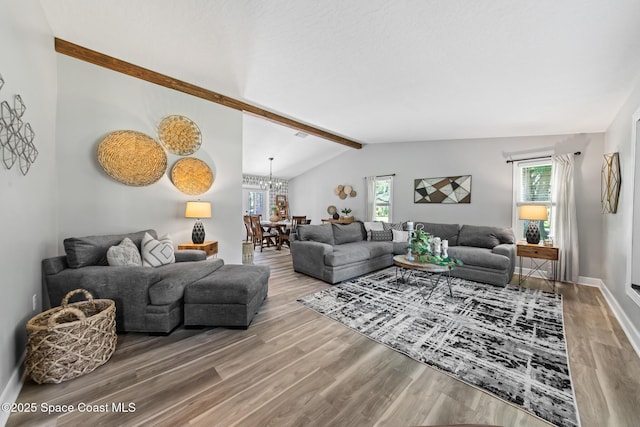 3203 Wind Song Ct, Melbourne, FL 32934 - living room featuring wood finished floors, a chandelier, and baseboards
