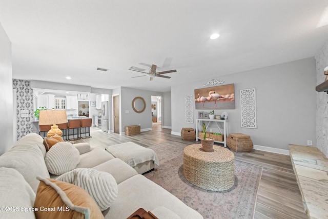 3203 Wind Song Ct, Melbourne, FL 32934 - living room featuring baseboards, a ceiling fan, light wood-style flooring, and recessed lighting