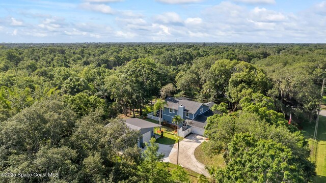 3203 Wind Song Ct, Melbourne, FL 32934 - aerial view of property and surrounding area featuring a heavily wooded area
