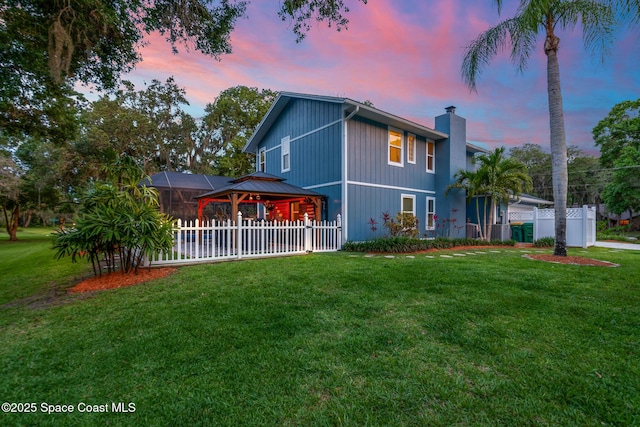 3203 Wind Song Ct, Melbourne, FL 32934 - property exterior at dusk with a gazebo and a chimney