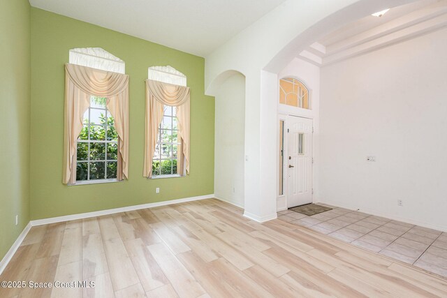 2703 Barrow Dr, Merritt Island, FL 32952 - unfurnished room with arched walkways, wood finished floors, and baseboards