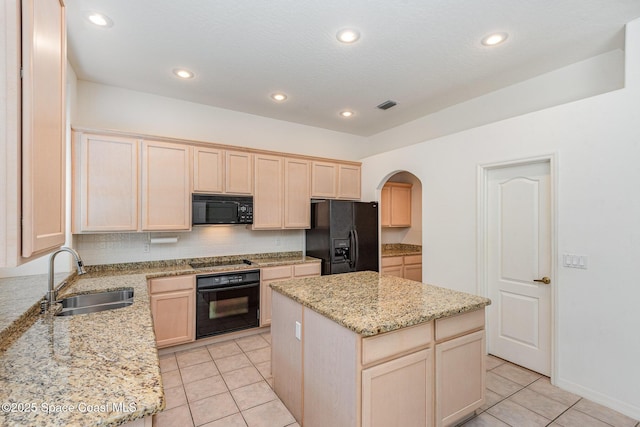 2703 Barrow Dr, Merritt Island, FL 32952 - kitchen with black appliances, a sink, arched walkways, light brown cabinetry, and light tile patterned floors