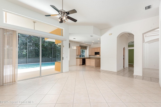 2703 Barrow Dr, Merritt Island, FL 32952 - unfurnished living room featuring arched walkways, ceiling fan, light tile patterned floors, healthy amount of natural light, and recessed lighting