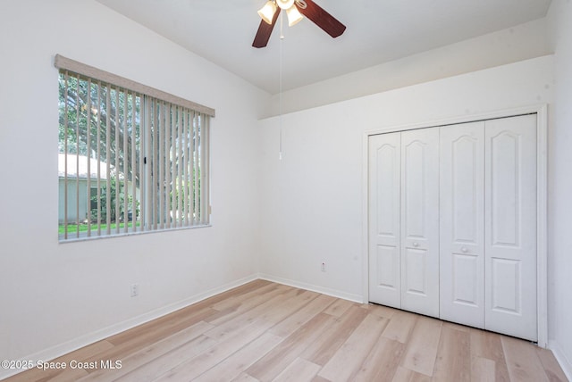 2703 Barrow Dr, Merritt Island, FL 32952 - unfurnished bedroom featuring light wood-style floors, a closet, baseboards, and a ceiling fan