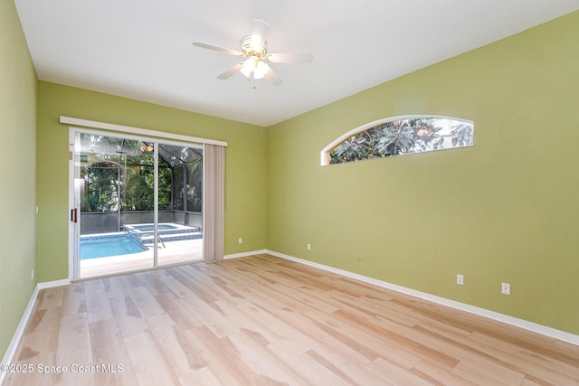 2703 Barrow Dr, Merritt Island, FL 32952 - spare room with ceiling fan, light wood finished floors, and baseboards