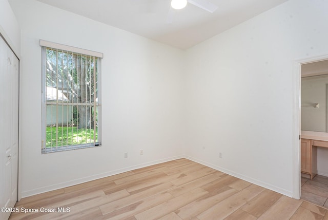 2703 Barrow Dr, Merritt Island, FL 32952 - unfurnished bedroom with light wood-style flooring, a closet, baseboards, and ceiling fan
