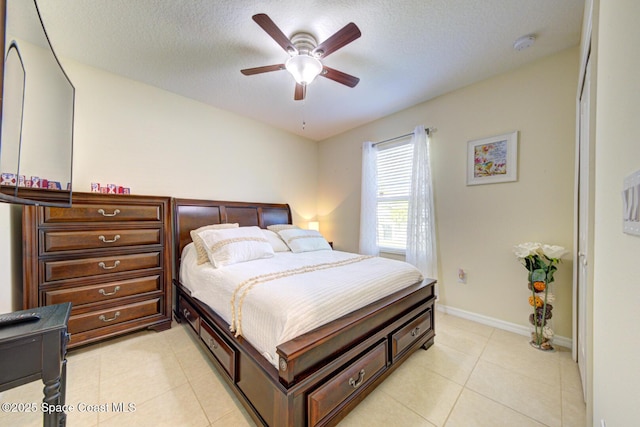 469 Aviation Ave NE, Palm Bay, FL 32907 - bedroom with a textured ceiling, light tile patterned floors, ceiling fan, and baseboards