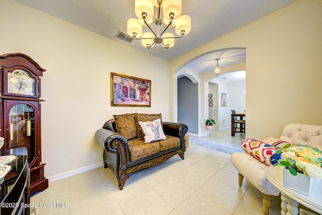 469 Aviation Ave NE, Palm Bay, FL 32907 - living area featuring arched walkways, a chandelier, light tile patterned floors, and baseboards