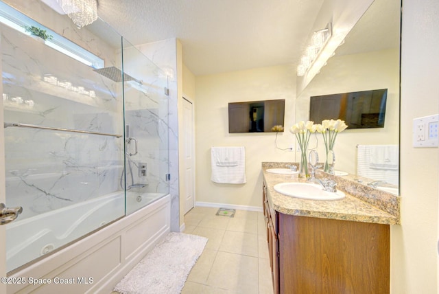 469 Aviation Ave NE, Palm Bay, FL 32907 - bathroom with double vanity, bath / shower combo with glass door, tile patterned flooring, and baseboards