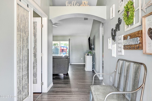 870 Buchanan Ave SE, Palm Bay, FL 32909 - entrance foyer with arched walkways, a ceiling fan, baseboards, and wood finished floors