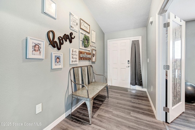 870 Buchanan Ave SE, Palm Bay, FL 32909 - foyer with baseboards, wood finished floors, and a textured ceiling