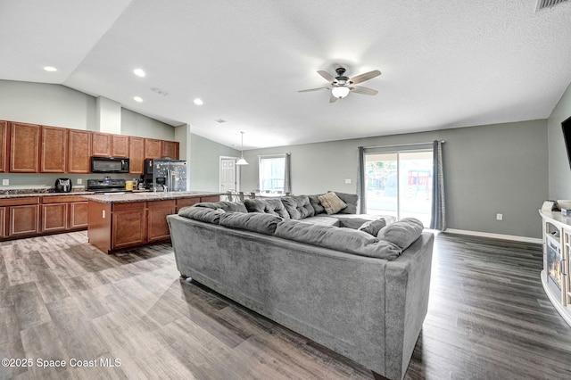 870 Buchanan Ave SE, Palm Bay, FL 32909 - living area with vaulted ceiling, ceiling fan, wood finished floors, recessed lighting, and baseboards