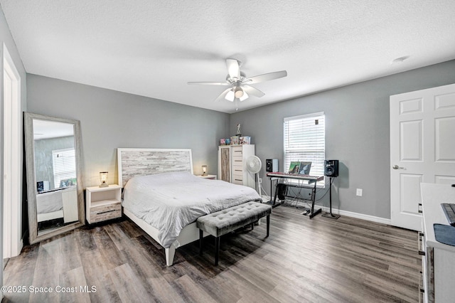 870 Buchanan Ave SE, Palm Bay, FL 32909 - bedroom featuring wood finished floors, baseboards, a ceiling fan, a textured ceiling, and an office area