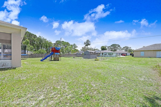 870 Buchanan Ave SE, Palm Bay, FL 32909 - view of yard with a trampoline and a playground