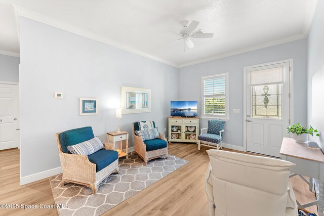 5853 Goldrush Ave, Grant-Valkaria, FL 32949 - sitting room featuring light wood-style floors, ornamental molding, ceiling fan, and baseboards