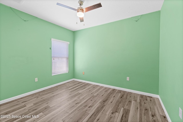 681 Dillard Dr SE, Palm Bay, FL 32909 - unfurnished room featuring wood finished floors, baseboards, and a ceiling fan
