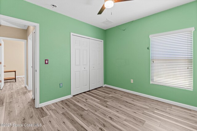 681 Dillard Dr SE, Palm Bay, FL 32909 - unfurnished bedroom with light wood-style flooring, a closet, baseboards, and ceiling fan