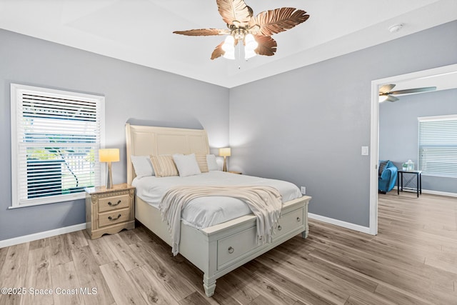 681 Dillard Dr SE, Palm Bay, FL 32909 - bedroom with light wood-style flooring, baseboards, and ceiling fan