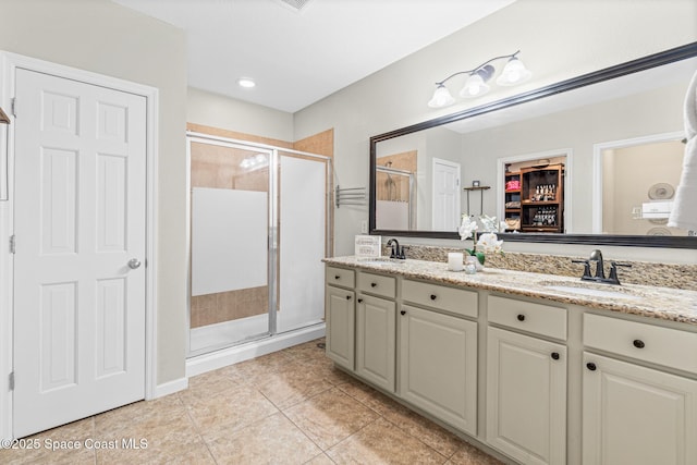 681 Dillard Dr SE, Palm Bay, FL 32909 - bathroom with double vanity, a stall shower, and tile patterned floors
