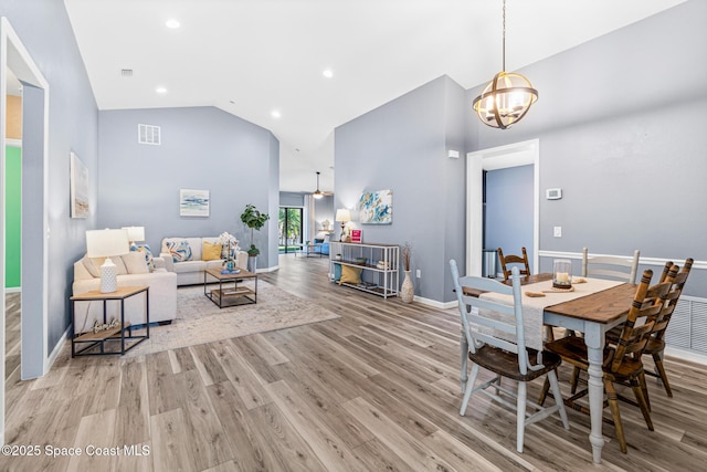 681 Dillard Dr SE, Palm Bay, FL 32909 - dining area featuring high vaulted ceiling, light wood finished floors, baseboards, a chandelier, and recessed lighting