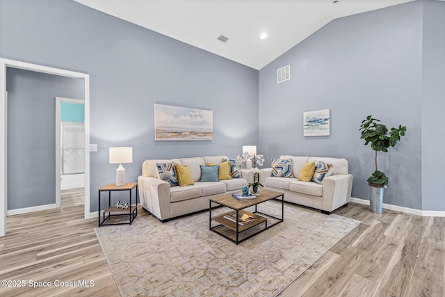 681 Dillard Dr SE, Palm Bay, FL 32909 - living room with wood finished floors, high vaulted ceiling, and baseboards