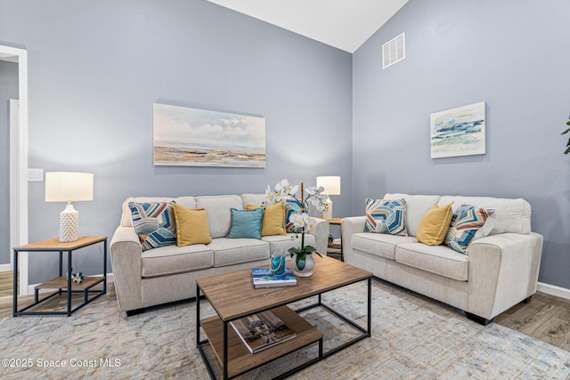 681 Dillard Dr SE, Palm Bay, FL 32909 - living room with wood finished floors, baseboards, and high vaulted ceiling