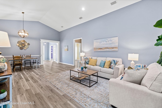 681 Dillard Dr SE, Palm Bay, FL 32909 - living area with high vaulted ceiling and wood finished floors