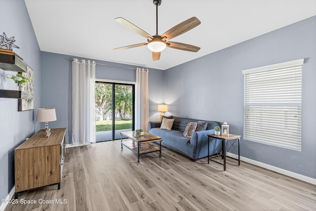 681 Dillard Dr SE, Palm Bay, FL 32909 - living room featuring ceiling fan, light wood-type flooring, and baseboards
