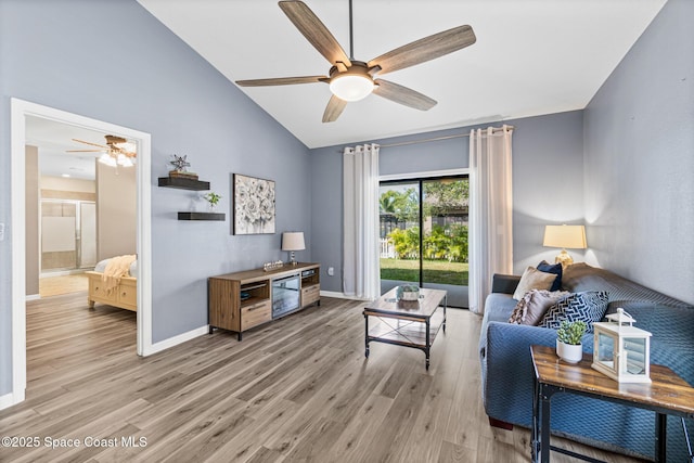 681 Dillard Dr SE, Palm Bay, FL 32909 - living area with a ceiling fan, light wood-style floors, baseboards, and high vaulted ceiling
