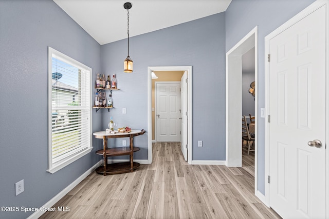 681 Dillard Dr SE, Palm Bay, FL 32909 - dining room with light wood-style flooring, baseboards, and vaulted ceiling