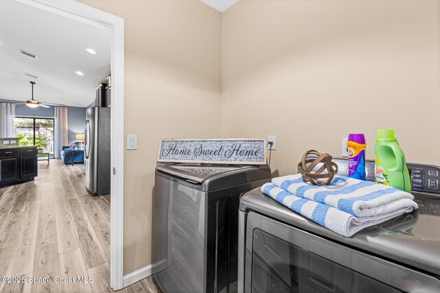 681 Dillard Dr SE, Palm Bay, FL 32909 - laundry area with washing machine and clothes dryer, light wood-style floors, ceiling fan, and baseboards