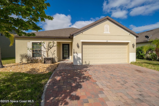 681 Dillard Dr SE, Palm Bay, FL 32909 - ranch-style house with stucco siding, decorative driveway, and a garage