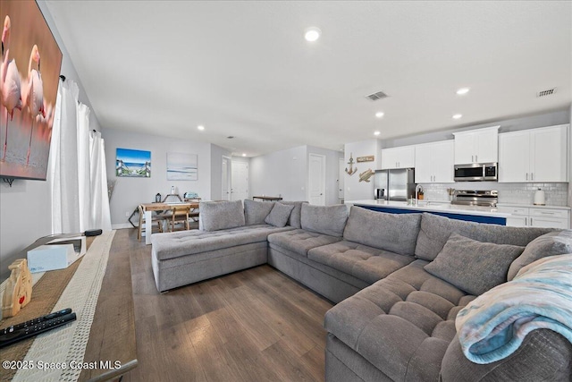 1160 Larkspur St SE, Palm Bay, FL 32909 - living area with dark wood-style flooring, recessed lighting, and baseboards