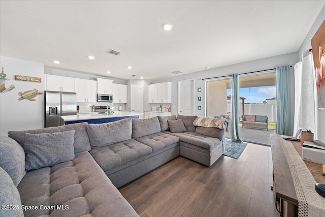 1160 Larkspur St SE, Palm Bay, FL 32909 - living room featuring dark wood finished floors and recessed lighting