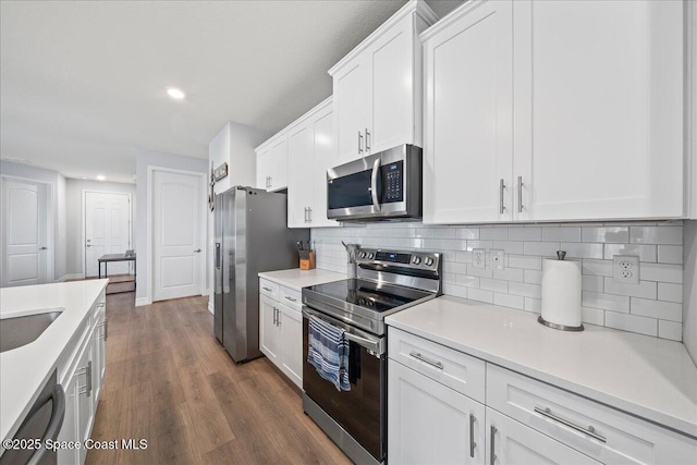 1160 Larkspur St SE, Palm Bay, FL 32909 - kitchen with appliances with stainless steel finishes, recessed lighting, white cabinets, light countertops, and backsplash