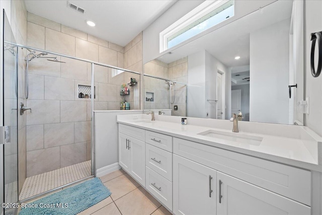 1160 Larkspur St SE, Palm Bay, FL 32909 - full bathroom with double vanity, a stall shower, tile patterned floors, and recessed lighting