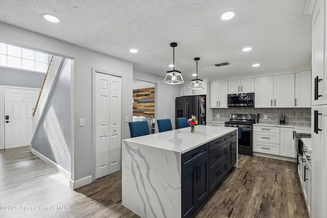 5060 Spinet Dr, Melbourne, FL 32940 - kitchen featuring stainless steel appliances, white cabinets, dark wood-type flooring, backsplash, and recessed lighting