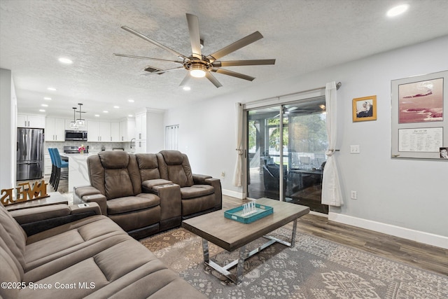 5060 Spinet Dr, Melbourne, FL 32940 - living area featuring recessed lighting, ceiling fan, wood finished floors, baseboards, and a textured ceiling